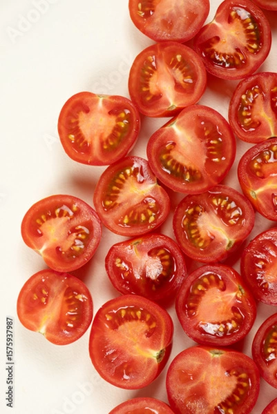 Fototapeta Small ripe tomatoes cut into halves macro top view