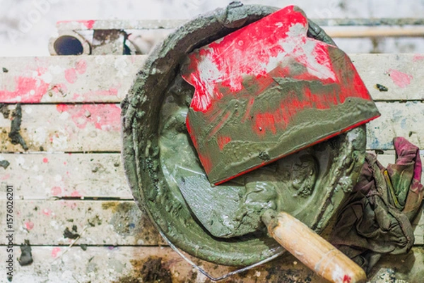 Obraz Cement mortar with a tool on the bucket