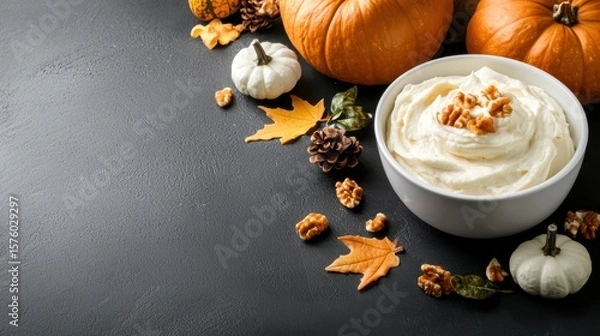 Fototapeta Delicious Bowl of Whipped Cream Surrounded by Pumpkins and Nuts in Fall