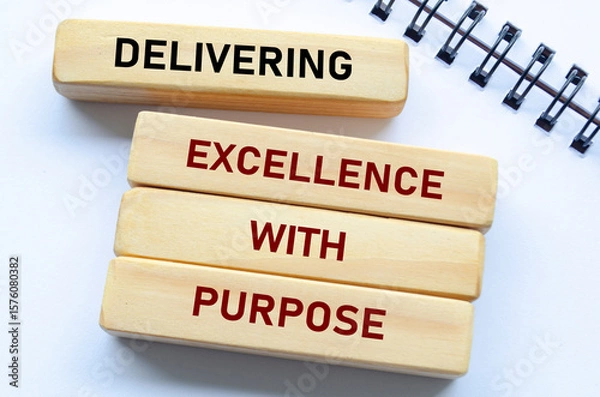 Fototapeta Delivering Excellence With Purpose text on wooden blocks. Quality delivery concept