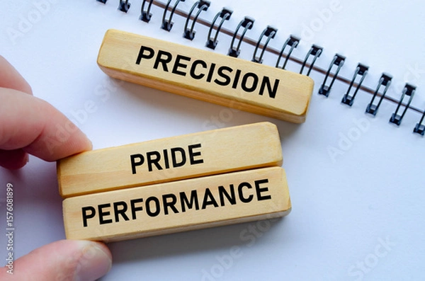 Fototapeta Precision through performance shown on wooden blocks over a notepad signifies the importance of accuracy in achieving success
