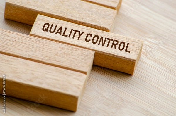 Fototapeta Quality Control text on wooden blocks. Business and Quality control concept