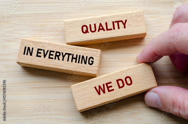 Fototapeta Quality in everything we do message on wooden blocks highlights a commitment to delivering consistent excellence