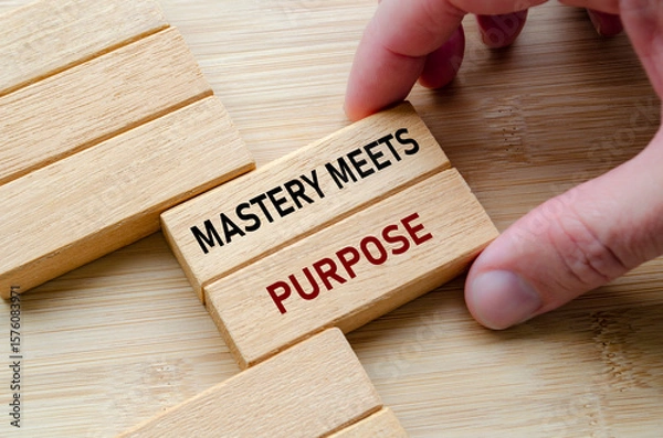 Fototapeta Mastery meets purpose text wooden block held in hand reflects skill, control, and experience achieved through practice