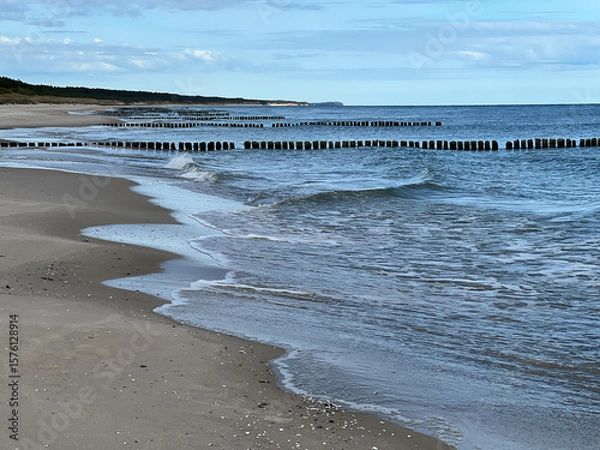 Fototapeta Empty Baltic beach in the Mrzezyno area in Poland with characteristic breakwaters made of pegs