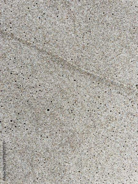 Fototapeta Sand on the Baltic Sea beach in Mrzezyno in Poland after being washed by a wave in close-up as a background