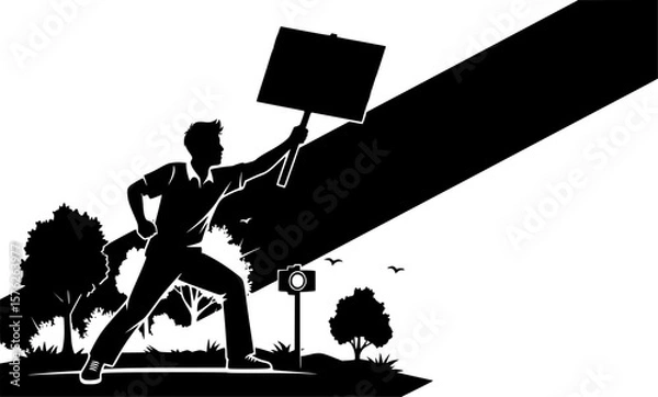 Fototapeta A silhouetted man holds a blank sign aloft in a dynamic pose, with a diagonal beam of light casting a shadow