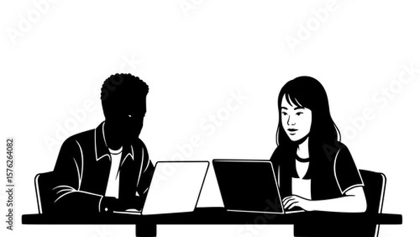 Fototapeta Two colleagues, one silhouetted and one facing forward, work together on laptops in a collaborative business setting