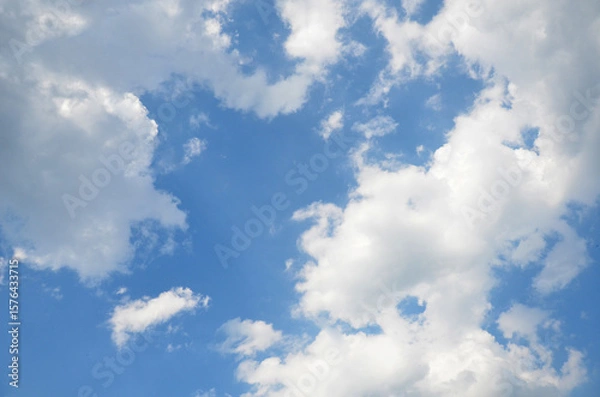 Fototapeta Bright blue sky with a frame of white clouds at the edges.