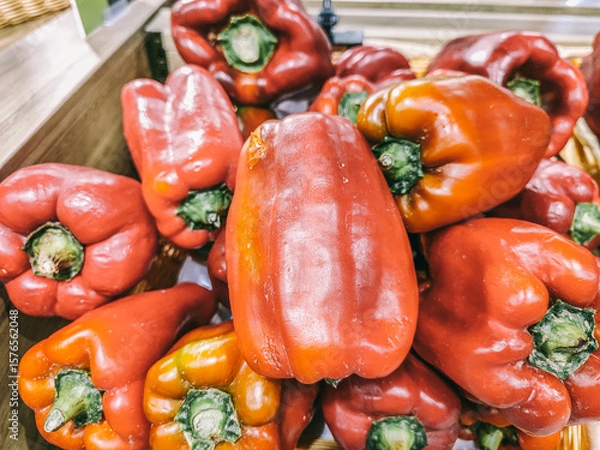 Fototapeta A bunch of red peppers are piled on top of each other