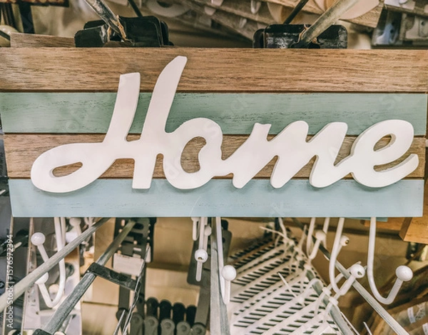 Fototapeta A sign that says home hangs on a rack