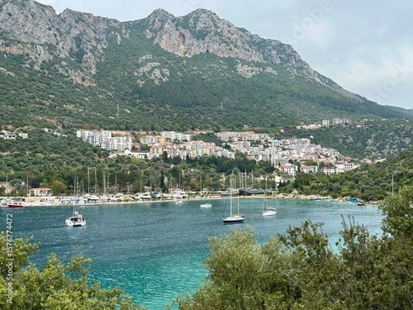 Fototapeta Ships and boats on the coastline in Antalya, Turkey with mountains and village in the background