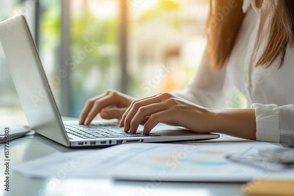 Fototapeta Female hands office manager typing on laptop. Closeup of businesswoman typing on laptop computer