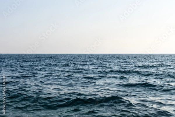 Fototapeta clear empty horizon line above still calm sea surface. natural composition with clarity, balance, and peaceful tones. minimalistic nature art