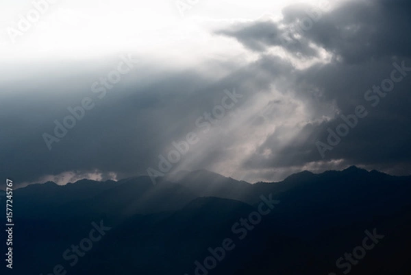 Obraz Sun Rays Breaking Through Clouds at Dusk