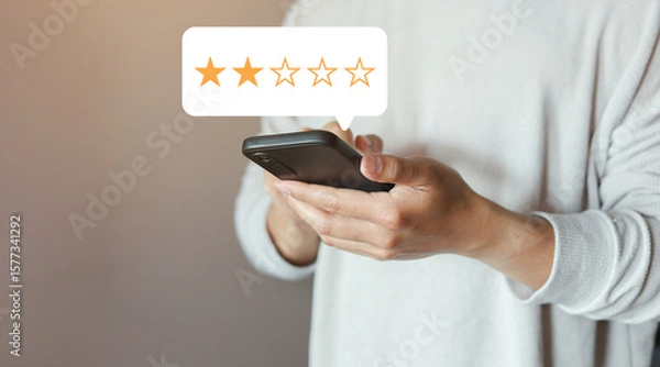 Fototapeta close up on customer man hand use smartphone and pressing two star (poor rating) feedback rank for give score point to review the service and experience on business concept