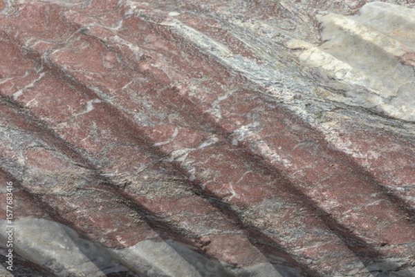 Fototapeta Spiral sculptural relief on the surface of a column in the ancient city of Perge in Turkey. Antique columns subject to erosion and ruins of an ancient city. Background of the column surface.