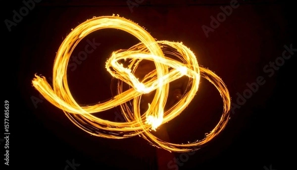 Fototapeta Flaming Light Forms Moving Gracefully Over Dark Void