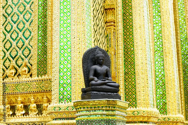 Fototapeta Serene Buddha Statue Surrounded by Intricate Golden Temple Design