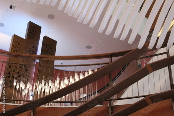 Fototapeta Modern Staircase with Hanging Lights and Decorative Panels in Elegant Interior Design