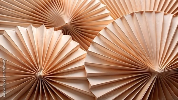 Fototapeta Several beige paper fans with intricate pleats are arranged in a pleasing composition, creating a textured background