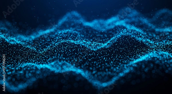 Fototapeta Abstract blue glowing particle wave background with dark backdrop and bright blue light effect design