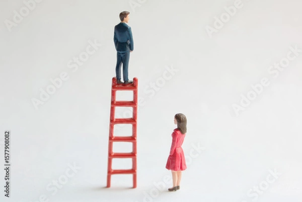 Fototapeta A man is on a red ladder, while a woman is looking up at him