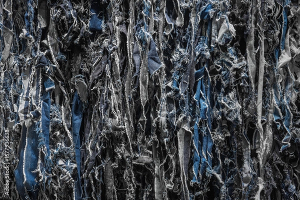 Fototapeta Detailed view highlighting the complex texture of torn denim repurposed as recycled jeans, showcasing eco-friendly fashion and sustainable textile methods for brands advocating for green practices.