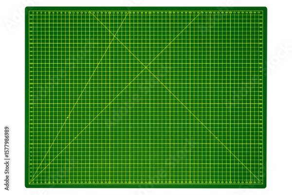 Fototapeta Large green cutting mat with yellow grid and measurement markings is isolated.
