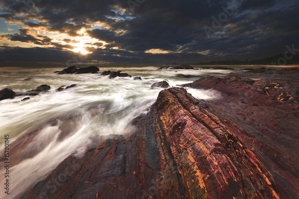 Fototapeta Naturally crafted rocks at the beach. Captured during a stormy weather.
