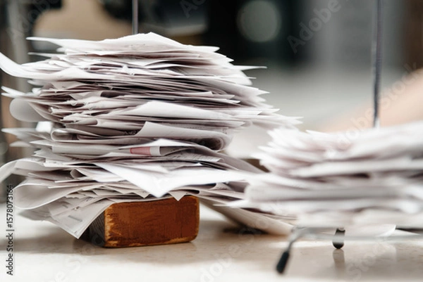 Fototapeta pile of spiked papers, restaurant and bar checks with orders on bar counter
