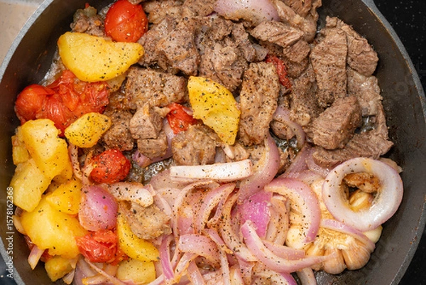 Obraz top view fresh home cooked beef dices on a pan