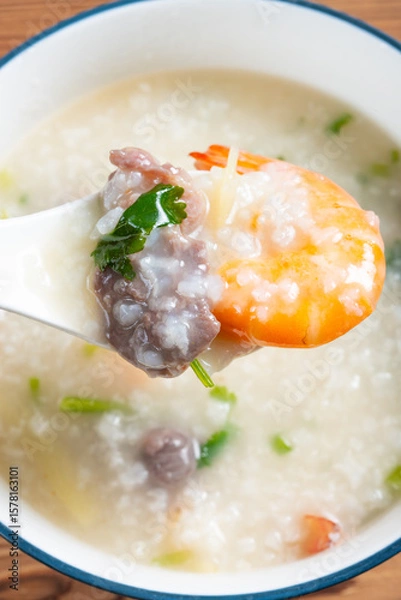 Obraz top view fresh shrimps and beef porridge at vertical composition