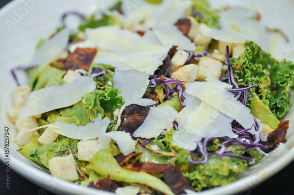 Fototapeta caesar salad or vegetable salad with bacon and cheese