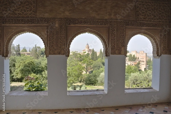 Fototapeta View of the Alhambra in Granada from some horseshoe arched windows