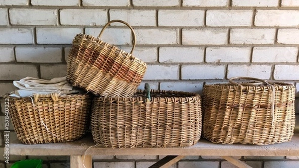 Obraz wicker basket on a wooden table, baskets made of willow twigs, handmade