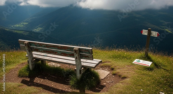 Fototapeta Serene mountain vista viewed from rustic wooden bench.