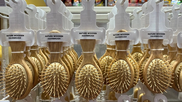 Fototapeta Rows of combs in many colors displayed in a shop. Goods neatly arranged in a display case