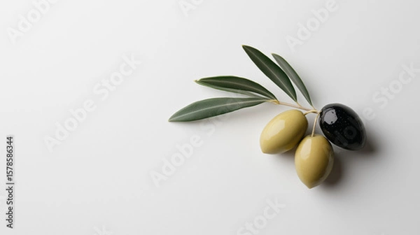 Fototapeta Fresh olives with leaves arranged on a light background, showcasing natural colors and textures in a culinary setting