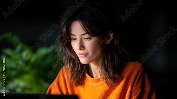 Fototapeta Dedicated Teacher Conducting Online Class with Focused Expression in Natural Light Setting