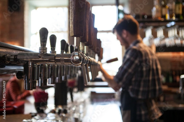 Obraz A lot of Golden beer taps at the bar