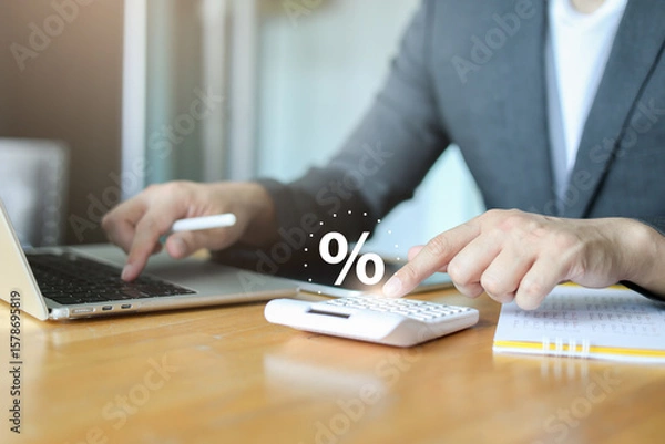 Fototapeta close up manager businessman hand press on calculator to calculate about commission rate form company's project after deal with client in office room for business lifestyle concept