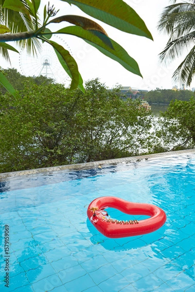 Fototapeta heart shaped float ,snorkeling, and summer items at the resort pool
