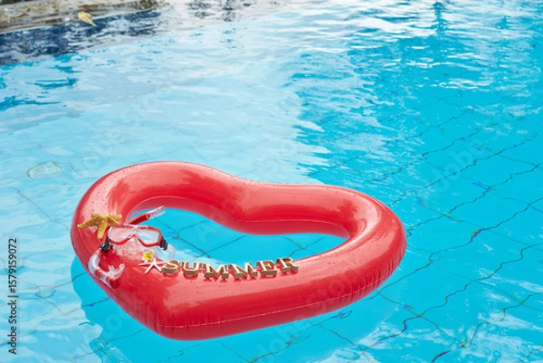 Fototapeta heart shaped float ,snorkeling, and summer items at the resort pool