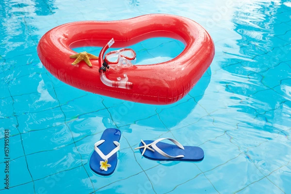 Fototapeta heart shaped float ,snorkeling, and summer items at the resort pool