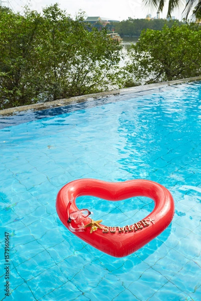Fototapeta heart shaped float ,snorkeling, and summer items at the resort pool