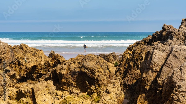 Fototapeta Rock formations in front of Liencres beach on a sunny summer day, Spain.