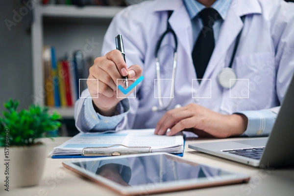 Fototapeta healthcare professional reviewing a patient medical record on a tablet while interacting with virtual icons and medical information displayed on the screen.