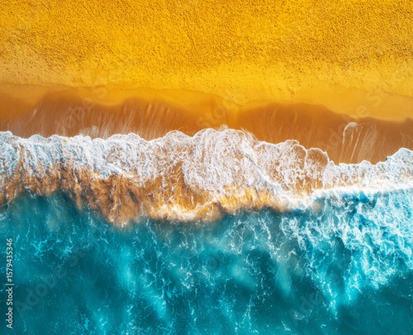 Fototapeta Aerial view of the beach with waves and sand. Bright ocean beach and water.