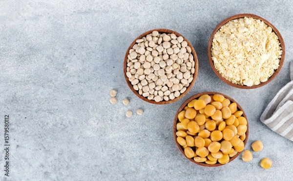 Fototapeta Gluten free lupine flour, dry lupine beans, protein rich snack of pickled lupine beans on gray background. Top view.